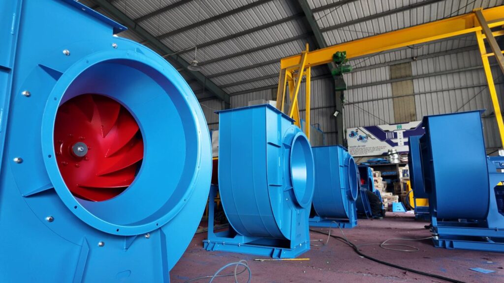 Industrial setting with large blue fans and equipment.