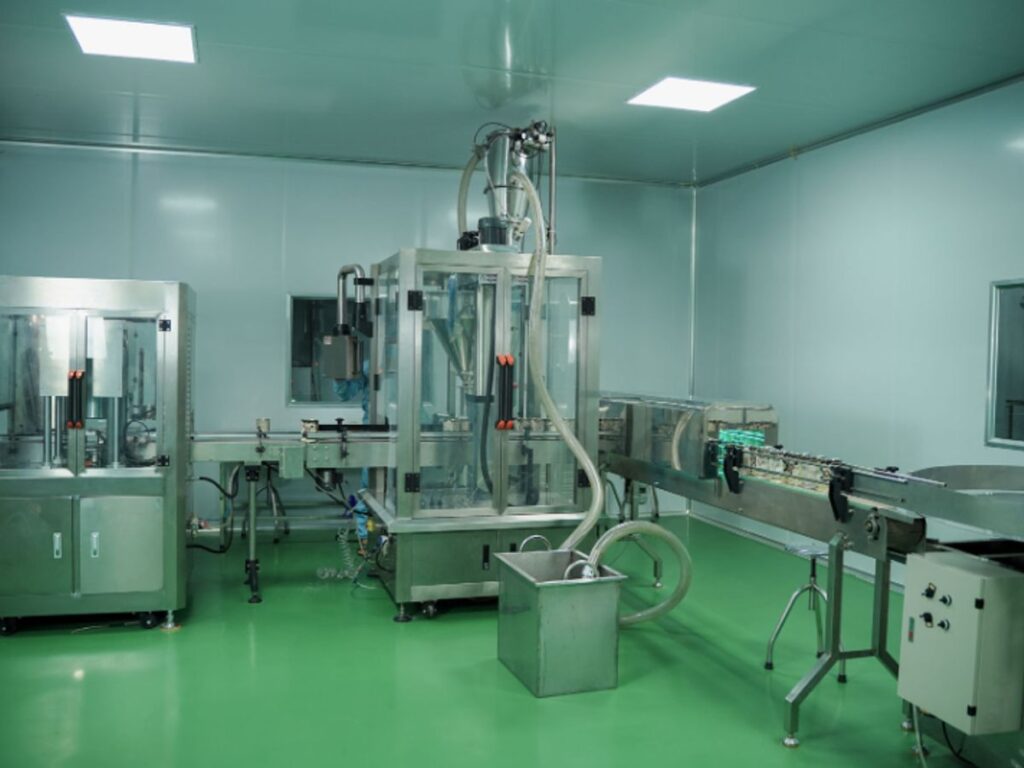 Clean industrial space with machines and conveyor belt system.