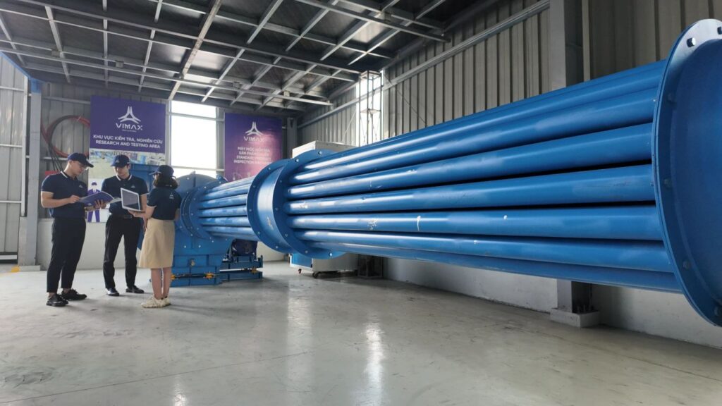 A large blue industrial machine in a spacious facility.