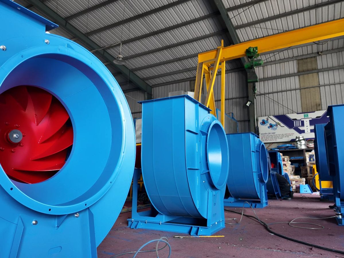 Industrial setting with large blue fans and equipment.